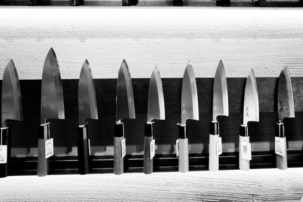 Row of traditional Japanese deba knives with wooden handles