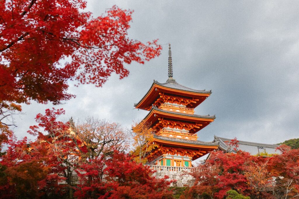 Kiyomizu-dera pagoda in Kyoto surrounded by red autumn maple leaves